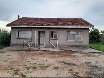 Cottage Sitting On Large Stand